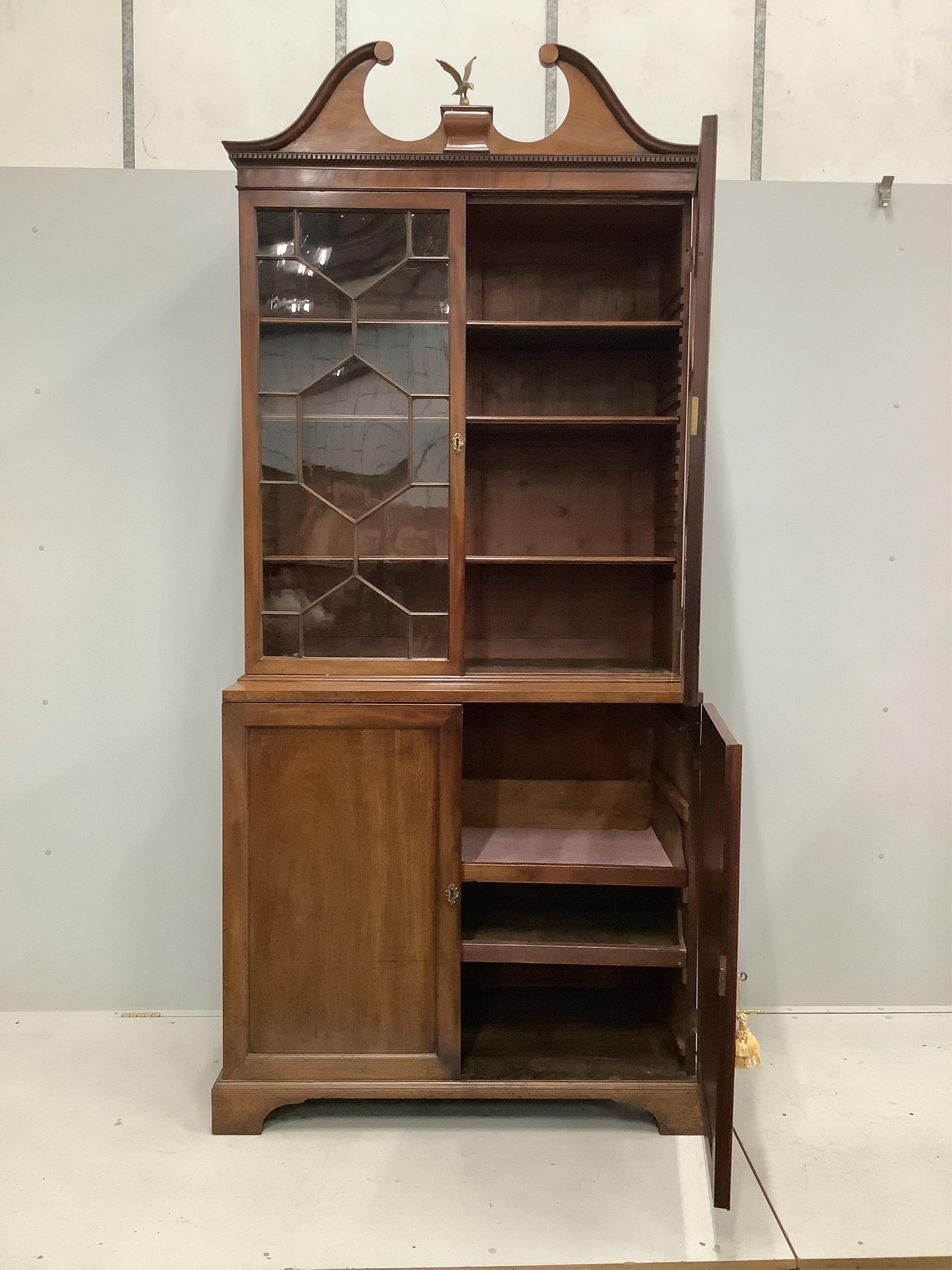 A George III mahogany bookcase cupboard, width 110cm, depth 56cm, height 248cm. Condition - fair